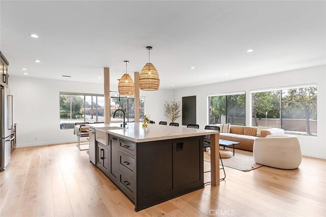 5681 E Colorado St, Long Beach, CA 90814 - kitchen featuring a sink, appliances with stainless steel finishes, light wood-type flooring, an island with sink, and recessed lighting