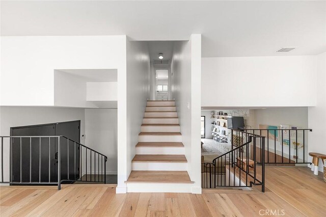 5681 E Colorado St, Long Beach, CA 90814 - stairway featuring wood finished floors and baseboards