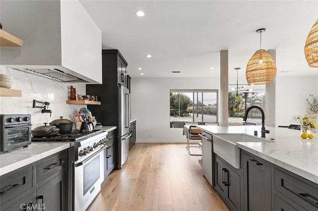 5681 E Colorado St, Long Beach, CA 90814 - kitchen featuring high quality appliances, a sink, extractor fan, open shelves, and light stone countertops
