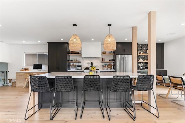 5681 E Colorado St, Long Beach, CA 90814 - kitchen featuring high quality fridge, open shelves, light countertops, decorative light fixtures, and light wood-style flooring