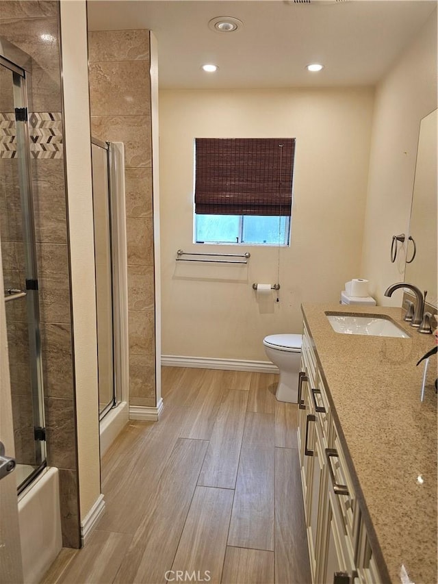 9315 Woodman Ave Unit 8, Arleta, CA 91331 - full bathroom featuring wood finished floors, a shower with shower door, double vanity, toilet, and a bathtub