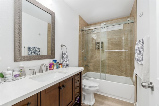11149 Liverpool Ln, Riverside, CA 92503 - full bath with toilet, wood finished floors, vanity, and combined bath / shower with glass door