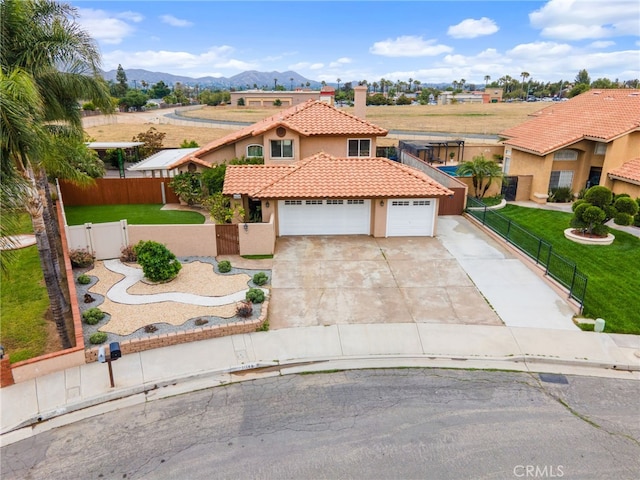 11149 Liverpool Ln, Riverside, CA 92503 - mediterranean / spanish-style house featuring a tiled roof, stucco siding, a gate, driveway, and a mountain view