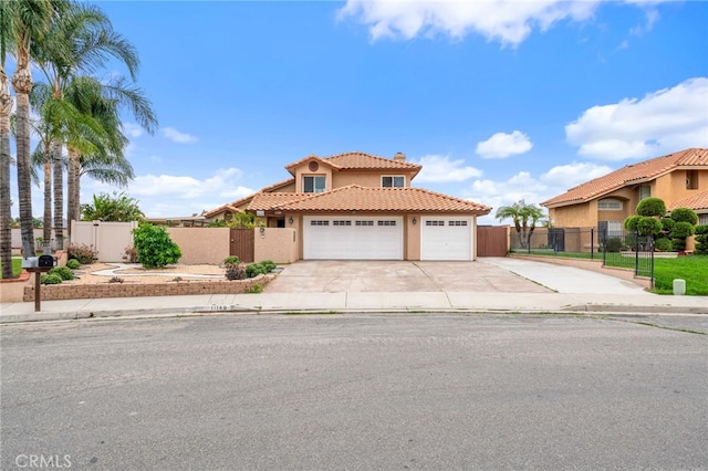 11149 Liverpool Ln, Riverside, CA 92503 - mediterranean / spanish-style home with stucco siding, an attached garage, a tiled roof, a gate, and fence