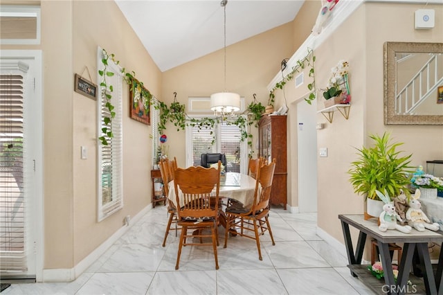 11149 Liverpool Ln, Riverside, CA 92503 - dining space with lofted ceiling, a chandelier, healthy amount of natural light, baseboards, and light marble finish flooring