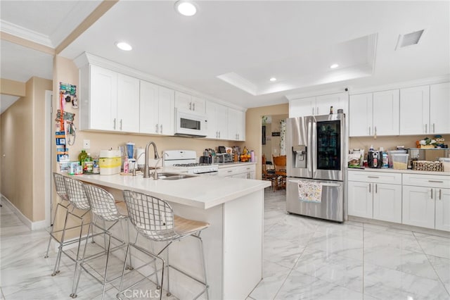 11149 Liverpool Ln, Riverside, CA 92503 - kitchen featuring white appliances, crown molding, a sink, a tray ceiling, and a kitchen breakfast bar