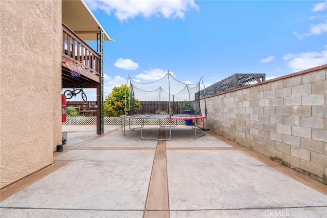 11149 Liverpool Ln, Riverside, CA 92503 - view of patio with a trampoline and a fenced backyard