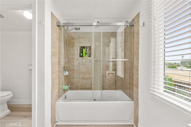 11149 Liverpool Ln, Riverside, CA 92503 - full bath featuring toilet, combined bath / shower with glass door, baseboards, and wood finished floors