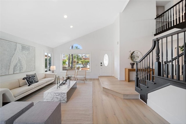 30901 Wellington Cir, Temecula, CA 92591 - living room featuring wood finished floors, high vaulted ceiling, stairway, and recessed lighting