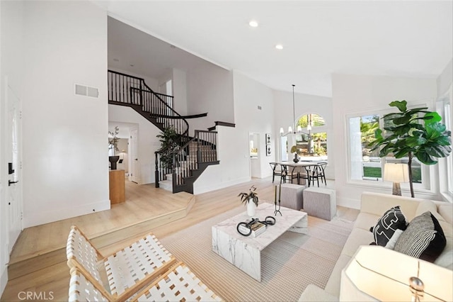30901 Wellington Cir, Temecula, CA 92591 - living area featuring high vaulted ceiling, stairs, light wood-style flooring, baseboards, and recessed lighting