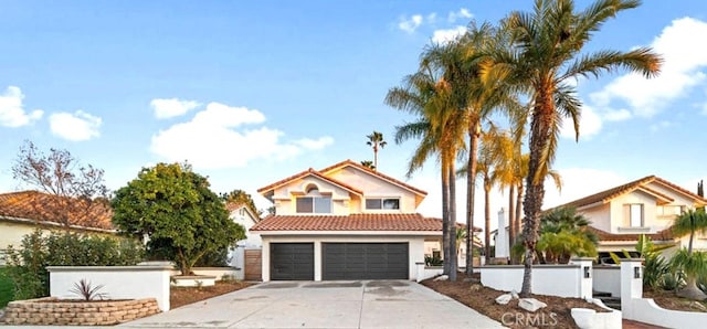 30901 Wellington Cir, Temecula, CA 92591 - view of front of house with driveway, a garage, stucco siding, a tiled roof, and fence