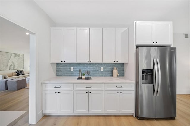30901 Wellington Cir, Temecula, CA 92591 - kitchen with stainless steel fridge with ice dispenser, white cabinets, tasteful backsplash, and light wood-style floors
