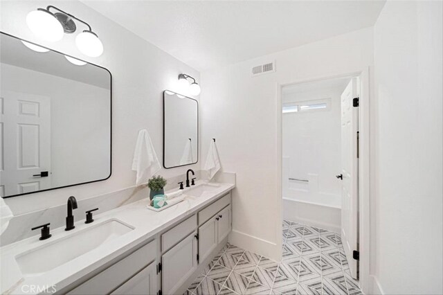 30901 Wellington Cir, Temecula, CA 92591 - bathroom with double vanity, baseboards, a bathtub, and tile patterned floors