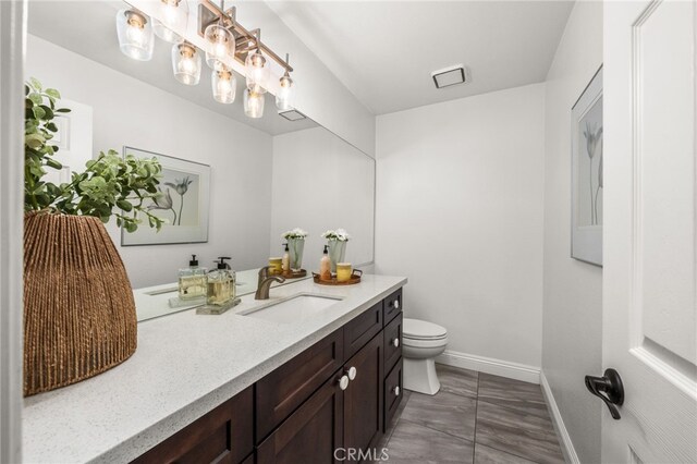 2130 Almeria St Unit 101, Corona, CA 92879 - bathroom with baseboards, toilet, and vanity