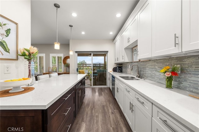2130 Almeria St Unit 101, Corona, CA 92879 - kitchen featuring a sink, dishwasher, dark brown cabinetry, white cabinetry, and tasteful backsplash