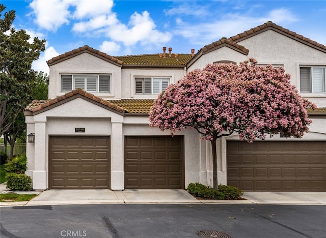 2130 Almeria St Unit 101, Corona, CA 92879 - view of front of house with a tiled roof, stucco siding, and an attached garage
