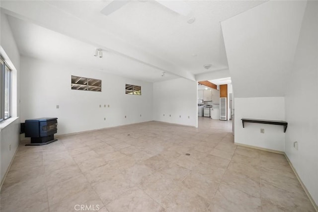 410 N Las Flores Dr, Nipomo, CA 93444 - unfurnished living room with a wood stove, a ceiling fan, and baseboards