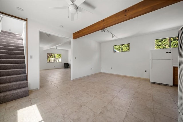 410 N Las Flores Dr, Nipomo, CA 93444 - empty room with beam ceiling, a ceiling fan, stairway, light tile patterned flooring, and baseboards