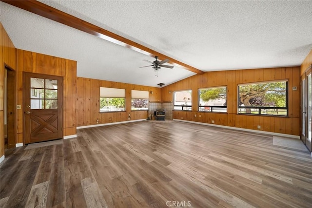 410 N Las Flores Dr, Nipomo, CA 93444 - unfurnished living room with wood finished floors, plenty of natural light, a textured ceiling, ceiling fan, and wooden walls