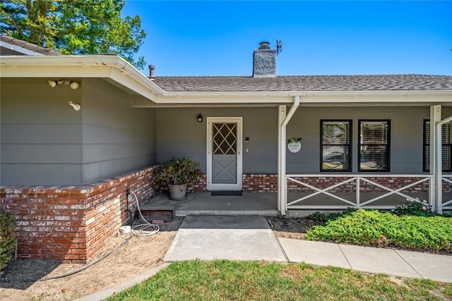410 N Las Flores Dr, Nipomo, CA 93444 - entrance to property featuring covered porch, a chimney, and roof with shingles