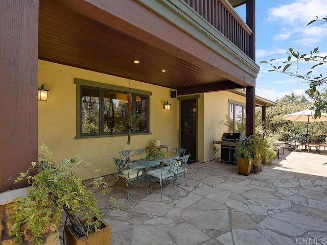 view of patio / terrace featuring outdoor dining area, a grill, and a balcony