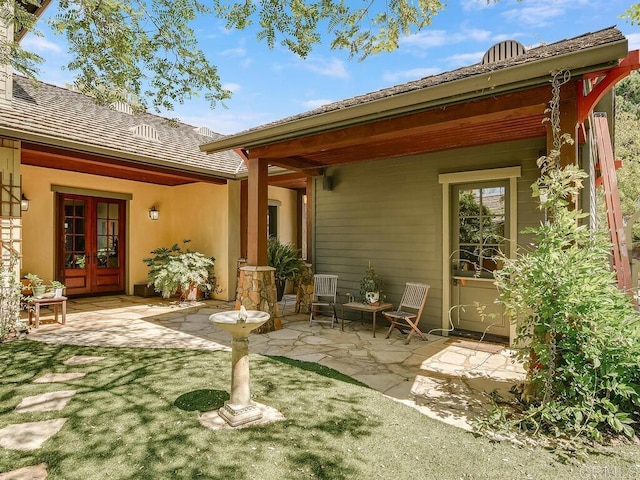 back of property featuring french doors and a patio area
