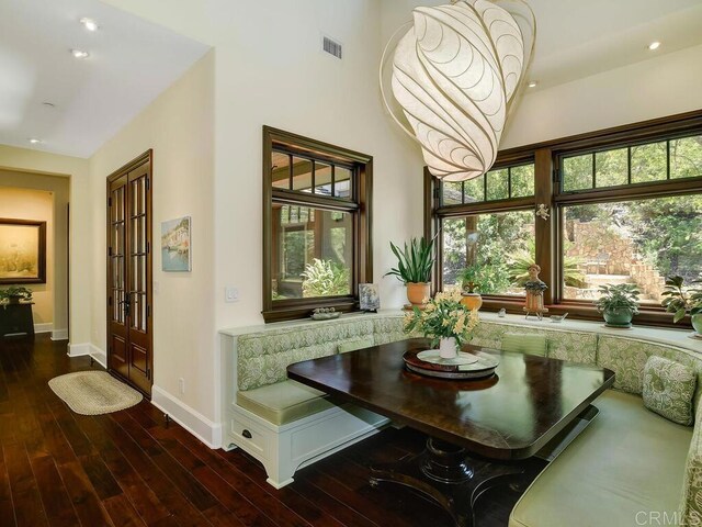 dining space featuring baseboards, plenty of natural light, recessed lighting, and wood finished floors