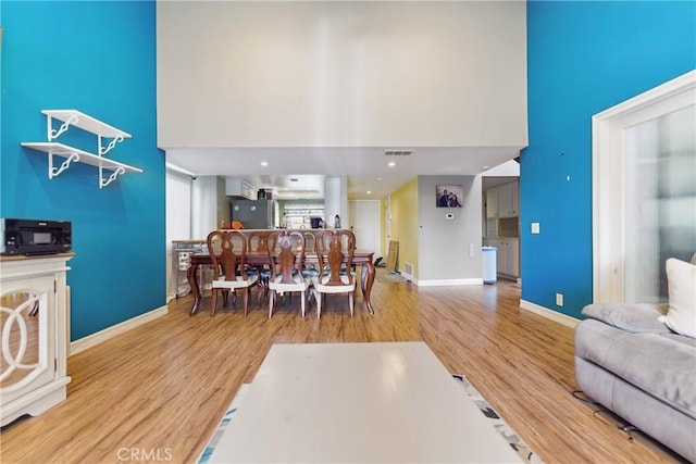 6621 Caro St Unit 111, Paramount, CA 90723 - living area with wood finished floors, a high ceiling, and baseboards
