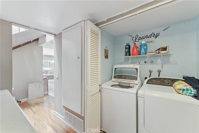 6621 Caro St Unit 111, Paramount, CA 90723 - laundry room with independent washer and dryer, light wood-style floors, and baseboards