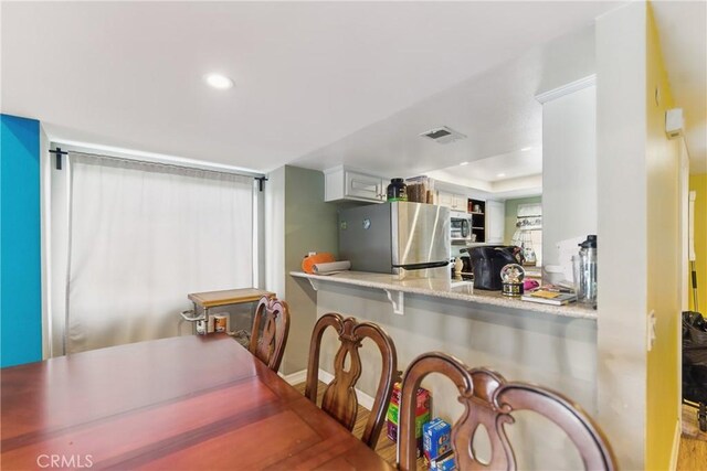 6621 Caro St Unit 111, Paramount, CA 90723 - kitchen with stainless steel appliances, recessed lighting, light countertops, wood finished floors, and a tray ceiling