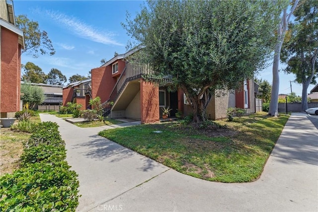 6621 Caro St Unit 111, Paramount, CA 90723 - view of front of property featuring stucco siding and stairs