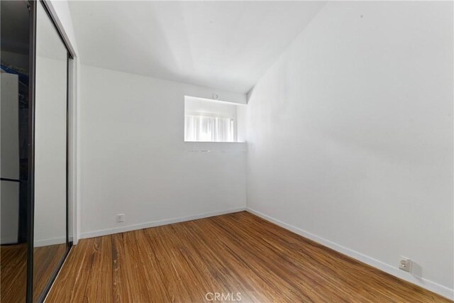 6621 Caro St Unit 111, Paramount, CA 90723 - unfurnished bedroom with wood finished floors, a closet, and baseboards