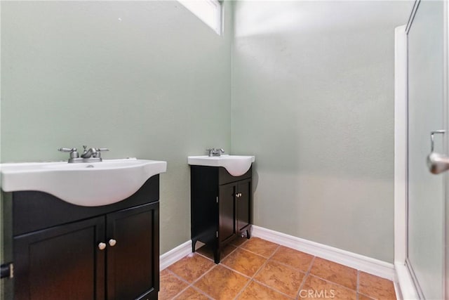 6621 Caro St Unit 111, Paramount, CA 90723 - bathroom featuring two vanities, baseboards, tile patterned flooring, and a shower with shower door