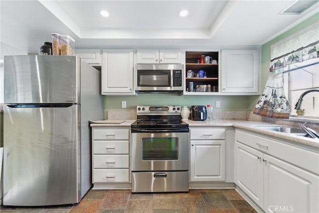 6621 Caro St Unit 111, Paramount, CA 90723 - kitchen featuring appliances with stainless steel finishes, white cabinets, dark stone finish flooring, a sink, and recessed lighting