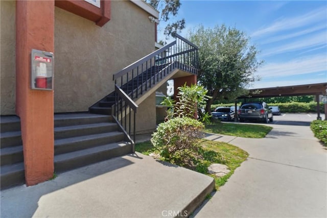 6621 Caro St Unit 111, Paramount, CA 90723 - view of side of property featuring stairway and stucco siding