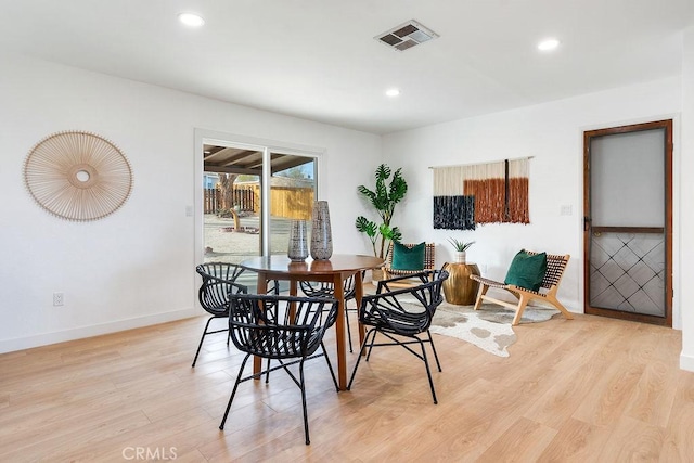 dining space with baseboards, light wood-style flooring, and recessed lighting