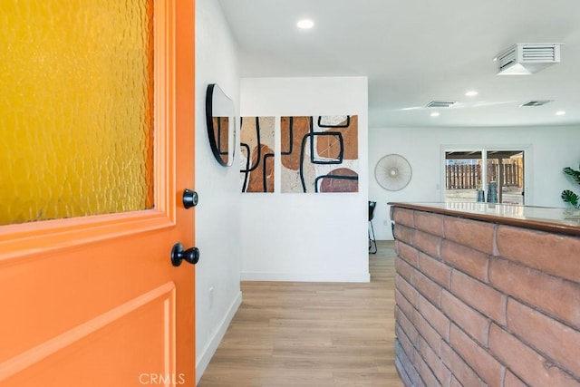 foyer entrance featuring wood finished floors, baseboards, and recessed lighting