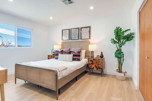 bedroom with light wood-style floors, recessed lighting, and baseboards