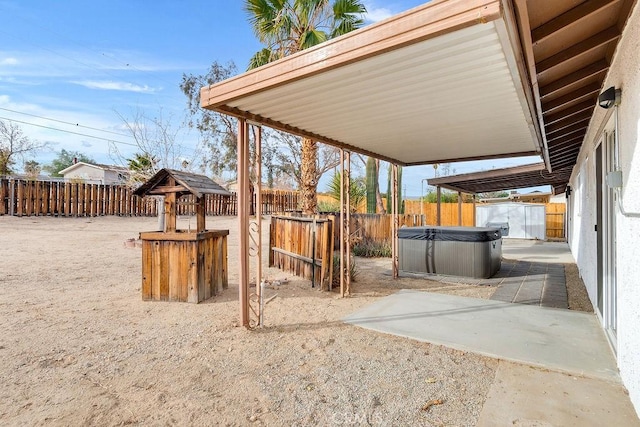 fenced backyard featuring a hot tub, a patio, a storage shed, and an outdoor structure