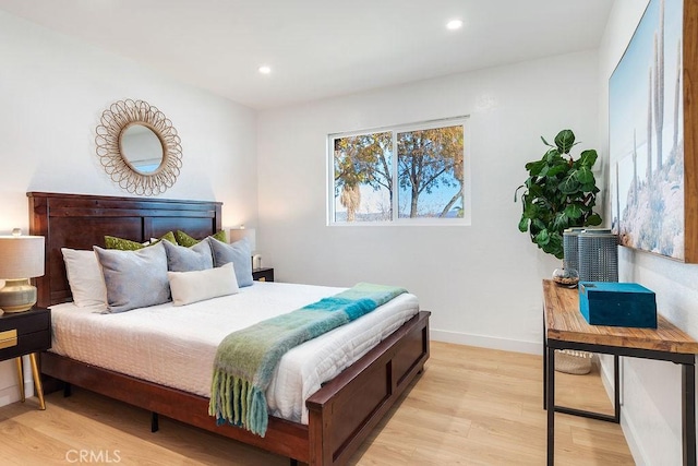 bedroom with light wood-style flooring, recessed lighting, and baseboards