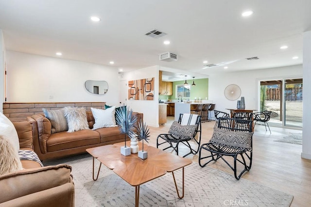 living room with recessed lighting and light wood-style flooring
