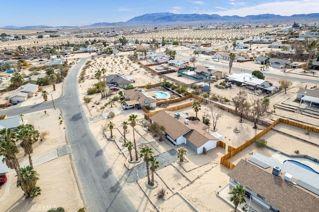 aerial view of residential area with a mountain backdrop and a desert landscape