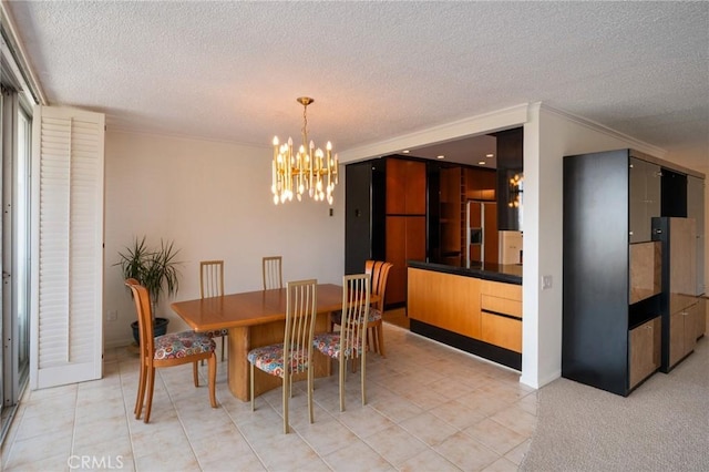 32735 Seagate Dr Unit 304-D, Rancho Palos Verdes, CA 90275 - dining area featuring a textured ceiling, a chandelier, light tile patterned flooring, and ornamental molding