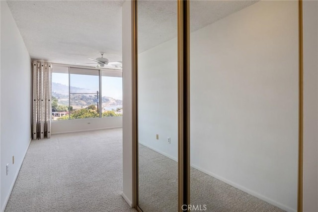 32735 Seagate Dr Unit 304-D, Rancho Palos Verdes, CA 90275 - interior space featuring carpet flooring, ceiling fan, baseboards, and a textured ceiling