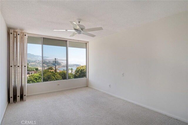 32735 Seagate Dr Unit 304-D, Rancho Palos Verdes, CA 90275 - unfurnished room featuring carpet flooring, baseboards, a ceiling fan, and a textured ceiling