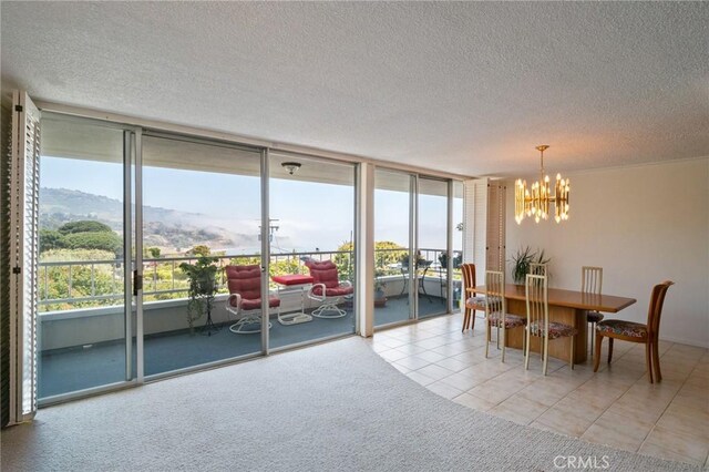 32735 Seagate Dr Unit 304-D, Rancho Palos Verdes, CA 90275 - dining area featuring a chandelier, a textured ceiling, plenty of natural light, expansive windows, and light tile patterned floors