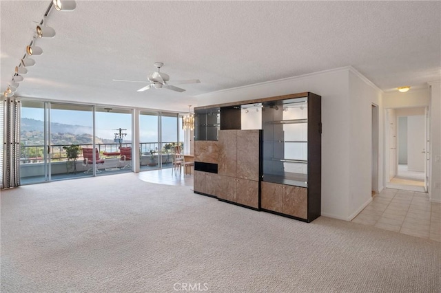 32735 Seagate Dr Unit 304-D, Rancho Palos Verdes, CA 90275 - unfurnished living room featuring track lighting, ceiling fan, light colored carpet, a textured ceiling, and a wall of windows