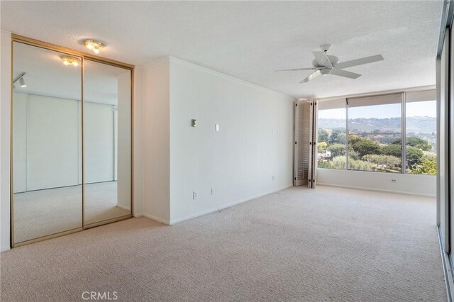32735 Seagate Dr Unit 304-D, Rancho Palos Verdes, CA 90275 - spare room with carpet floors, ceiling fan, baseboards, a textured ceiling, and crown molding
