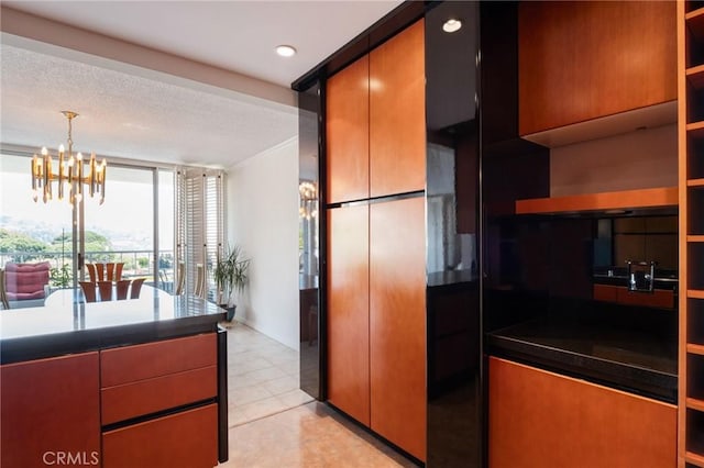 32735 Seagate Dr Unit 304-D, Rancho Palos Verdes, CA 90275 - kitchen featuring open shelves, a chandelier, dark countertops, light tile patterned floors, and pendant lighting