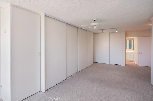 32735 Seagate Dr Unit 304-D, Rancho Palos Verdes, CA 90275 - basement featuring ceiling fan, carpet, a textured ceiling, and rail lighting